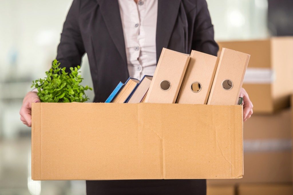 "Businessman holding carboard box
