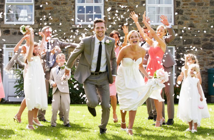 guests throwing confetti over bride and groom