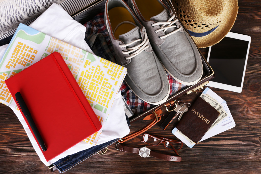 travel things with map and other things in the suitcase