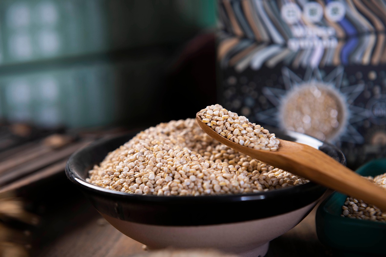 quinoa in a ceramic bowl and a wooden spoon